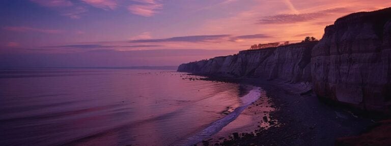 a stunning view of whidbey island's coastal cliffs at sunset, where the vibrant orange and purple skies reflect on serene waters, symbolizing the harmonious relationship between user experience and enhanced seo rankings.