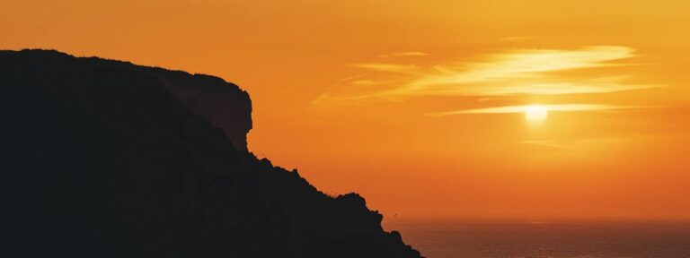 a vibrant sunset casts golden hues over the rugged cliffs of whidbey island, symbolizing the seamless integration of mobile web design optimization and the natural beauty of technology meeting nature.